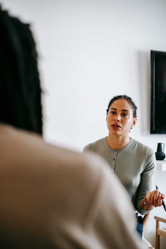 A therapist listens attentively during a counseling session, promoting open communication.